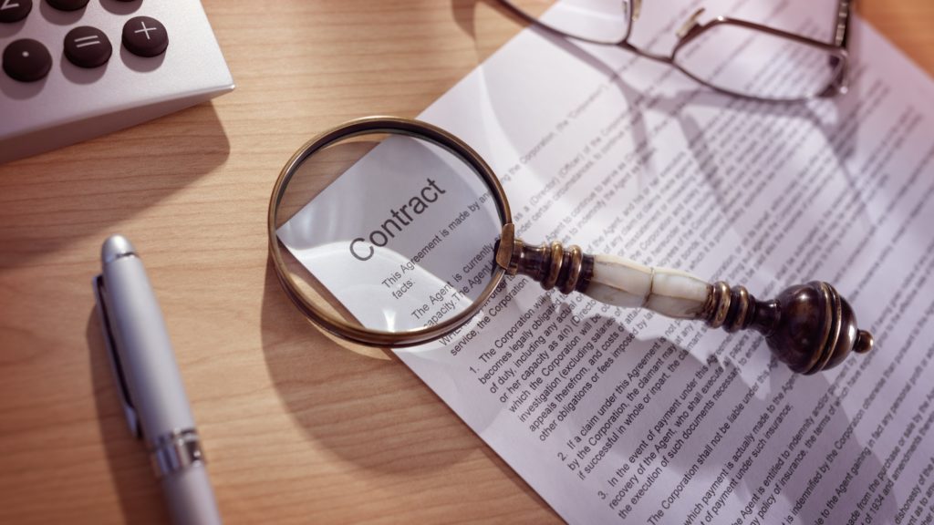 Magnifying glass on a legal contract